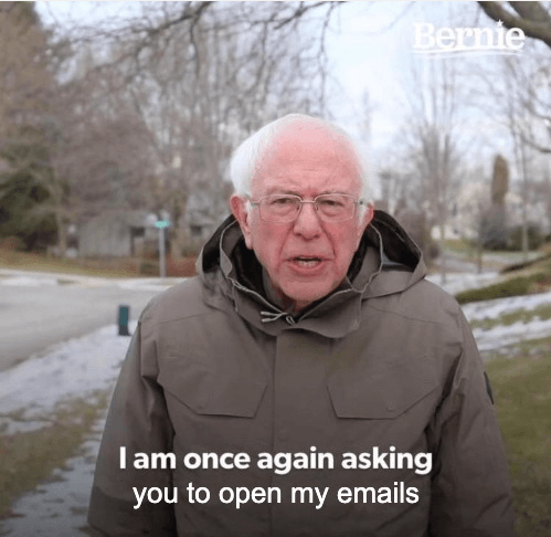 Bernie Sanders meme looking directly at the camera with his mouth open as if speaking. Text below says "I am once again asking you to open my emails"