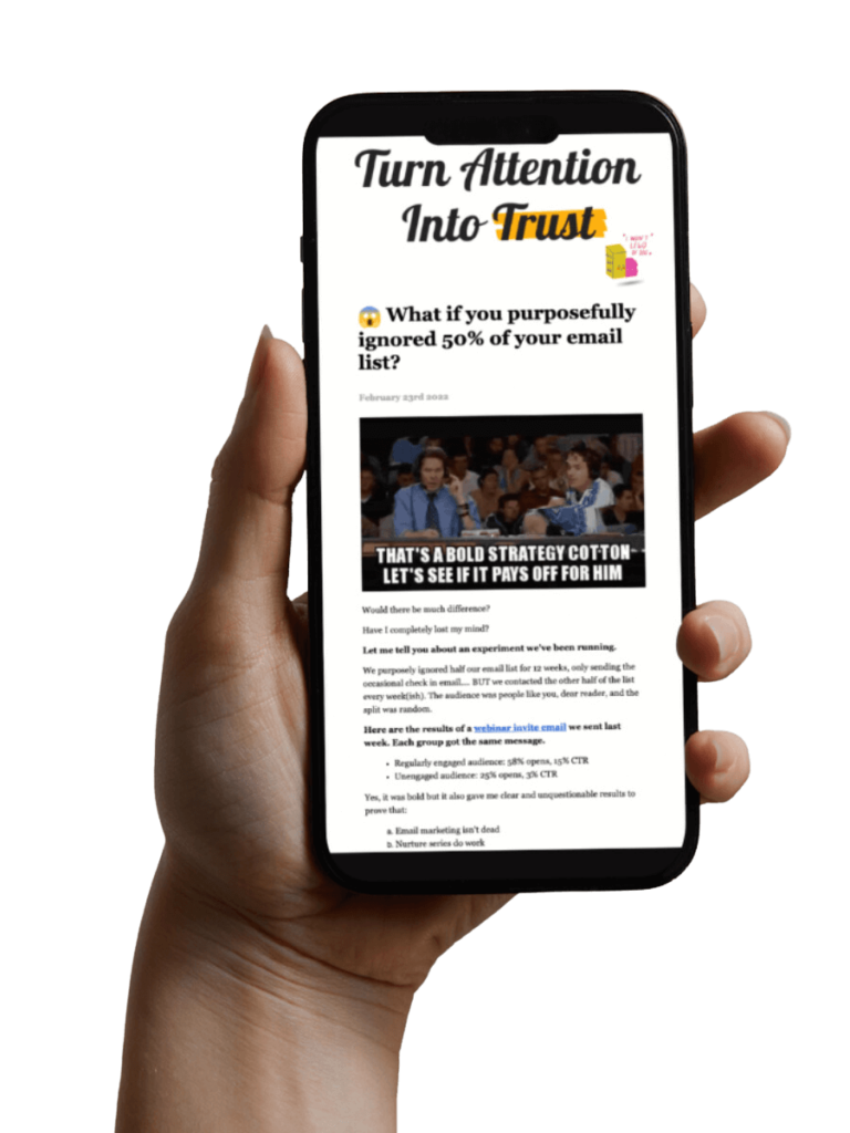 Hand holding iPhone reading the TAIT marketing to schools newsletter