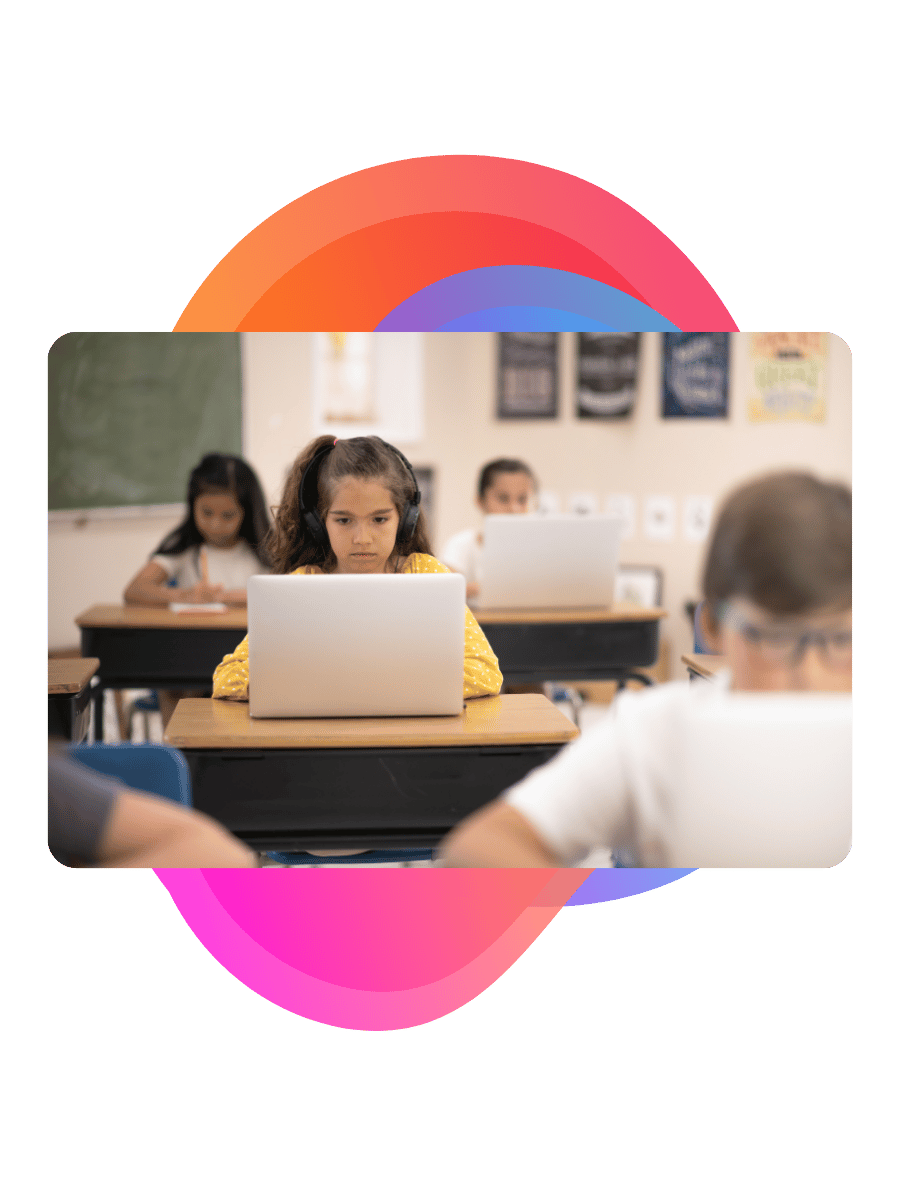 Child using a laptop in a classroom